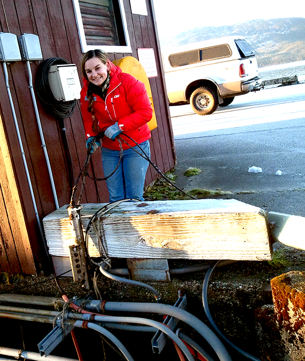 Megan Roberts retrieves the conductivity sensor at the Cordova tide station to inspect it for fouling.