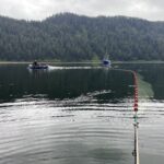 one boat pulling a seine fishing net