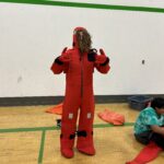 high school girl in a red survival suit